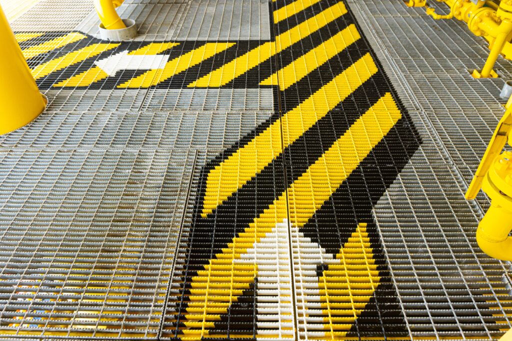 Health and safety walkway mesh with black and yellow hazard arrrows